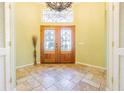 Elegant entryway with double doors and a stained glass window at 131 Mystic Lake N Dr, St Petersburg, FL 33702