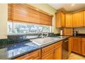 Kitchen with granite countertops and wooden cabinets at 131 Mystic Lake N Dr, St Petersburg, FL 33702