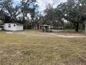 Spacious backyard with mature trees and open space at 1319 Vance Rd, Plant City, FL 33566