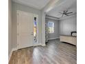 Bright entryway with tile flooring, white door, and view into home office at 13307 Fawn Lily Dr, Riverview, FL 33579