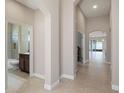 Spacious hallway leads to a bathroom with a tub and vanity, offering convenient access for guests at 1838 Tallulah Ter, Wesley Chapel, FL 33543
