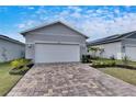 Two-car garage with paver driveway and nicely landscaped front yard at 2584 89Th Street E Cir, Palmetto, FL 34221
