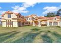 Grand estate with covered entryway, multiple garages, and manicured lawn at 309 Pruett Rd, Seffner, FL 33584