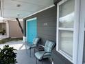 Gray house with teal garage door and front porch at 3148 Harvardston Loop, Holiday, FL 34691