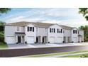 New townhome development showcasing three-story homes with two-car garages at 495 Mangrove Shade Cir, Apollo Beach, FL 33572