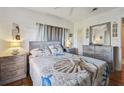 Cozy bedroom with a comfortable bed and wood floors at 5570 4Th N Ave, St Petersburg, FL 33710