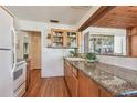 Kitchen boasts granite countertops and wood cabinets at 5570 4Th N Ave, St Petersburg, FL 33710