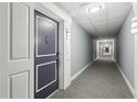 Clean condo hallway with carpeted floor and neutral walls at 880 Mandalay Ave # C1103, Clearwater Beach, FL 33767