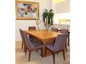 Elegant dining room featuring a large wood table and six striped chairs at 7108 Saint Andrews Ln, Sarasota, FL 34243