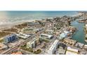 Aerial view of beachfront property, showcasing a multi-story building and ocean at 11605 Gulf Blvd # 505, Treasure Island, FL 33706