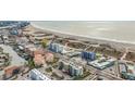 Aerial view of beachfront property, showcasing a multi-story building and ocean at 11605 Gulf Blvd # 505, Treasure Island, FL 33706