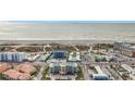 Aerial view of beachfront property, showcasing a multi-story building and ocean at 11605 Gulf Blvd # 505, Treasure Island, FL 33706