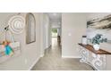 Bright and airy entryway with a console table and mirror at 1516 Hammer Pl, Largo, FL 33774