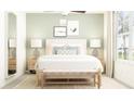 Bedroom with light walls, queen bed, and natural light at 17542 Shirewood Way, Land O Lakes, FL 34638