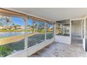 Screened porch overlooking a pond and serene landscape at 2243 Greenwich Dr, Sun City Center, FL 33573