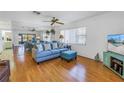 Living room features a blue sofa, ottoman, and large mirror reflecting the space at 2530 Oakleaf Ln # 31A, Clearwater, FL 33763