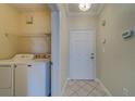 Laundry room with washer, dryer, and shelving at 2741 Via Cipriani # 930A, Clearwater, FL 33764