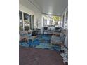 Relaxing front porch with wicker furniture and blue rug at 3562 90Th N Ter, Pinellas Park, FL 33782