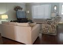 Living room with hardwood floors, sofa, and recliner at 3562 90Th N Ter, Pinellas Park, FL 33782