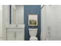 Modern bathroom with white subway tiles, a white vanity, and a shower/tub combo at 3760 Capital Reserve Dr, Plant City, FL 33565