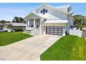 Modern white house with metal roof, attached garage, and spacious lawn at 4329 Helena Ne St, St Petersburg, FL 33703