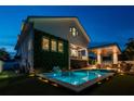 Luxury pool with outdoor kitchen and fire pit at night at 4329 Helena Ne St, St Petersburg, FL 33703