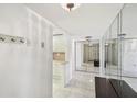 Entryway with mirrored walls, tiled floors, and a bench at 5200 Brittany S Dr # 1110, St Petersburg, FL 33715