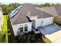 Two-story house with solar panels and a three-car garage at 5418 Wayfarer Ave, Apollo Beach, FL 33572