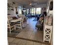 Bright living room with tile floors, featuring a dining area and access to a screened patio at 6104 Palma Del Mar S Blvd # 104, St Petersburg, FL 33715