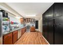 Galley kitchen with stainless steel appliances and wood flooring at 10809 Bartolotti Loop, Seffner, FL 33584