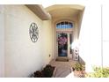 Inviting entryway with a glass front door and decorative wreath at 11021 Edge Park Dr, Hudson, FL 34667
