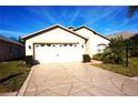 Front view of a single-story house with a white garage door at 11021 Edge Park Dr, Hudson, FL 34667