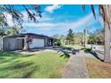 House exterior, green lawn, and street view at 1206 Meadowcrest Dr, Valrico, FL 33594
