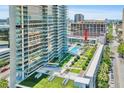 Aerial view showcasing a high-rise building with a pool and courtyard at 145 2Nd S Ave # 520, St Petersburg, FL 33701