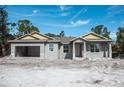 New construction home with gray siding and yellow accents at 15084 Mcgraw Ave, Port Charlotte, FL 33953