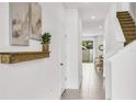 Bright and airy entryway with staircase and view to backyard at 1540 Hammer Pl, Largo, FL 33774