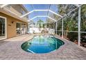 Inviting kidney-shaped pool with a screened enclosure at 15815 Muirfield Dr, Odessa, FL 33556