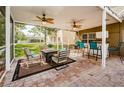 Relaxing screened patio with seating area and a built-in bar at 15815 Muirfield Dr, Odessa, FL 33556