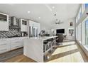 Modern kitchen with white cabinets, large island, and stainless steel appliances at 21 Crescent S Pl, St Petersburg, FL 33711