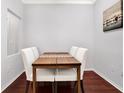 Simple dining area with wood table and white chairs at 501 Knights Run Ave # 2216, Tampa, FL 33602