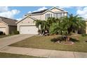 Two-story house with a large driveway and palm trees at 5119 11Th E St, Bradenton, FL 34203