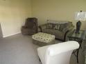 Living room with two armchairs and ottoman at 5876 21St N St # 3, St Petersburg, FL 33714