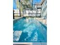 Inviting, refreshing blue swimming pool with cascading water feature at 6047 Twin Bridges Dr, Zephyrhills, FL 33541