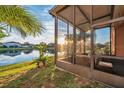 Relaxing screened porch overlooking a lake, perfect for enjoying sunsets at 613 Tanana Fall Dr, Ruskin, FL 33570
