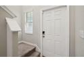 Home entry with staircase, neutral walls, and a white door at 7402 Evening Primrose Ct, Tampa, FL 33619