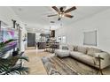 Open living room, sectional sofa, and kitchen views at 8405 N Arden Ave, Tampa, FL 33604