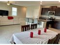 Kitchen and dining area with dark cabinets and granite countertops at 13621 Willow Bluestar Loop, Riverview, FL 33579