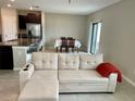 Open living room and kitchen with beige walls and tile floors at 13621 Willow Bluestar Loop, Riverview, FL 33579