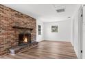 Living room with brick fireplace and new flooring at 25888 Whipperwill St, Brooksville, FL 34601