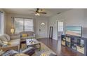 Living room features hardwood floors, a sofa and a TV at 2701 W Cordelia St, Tampa, FL 33607